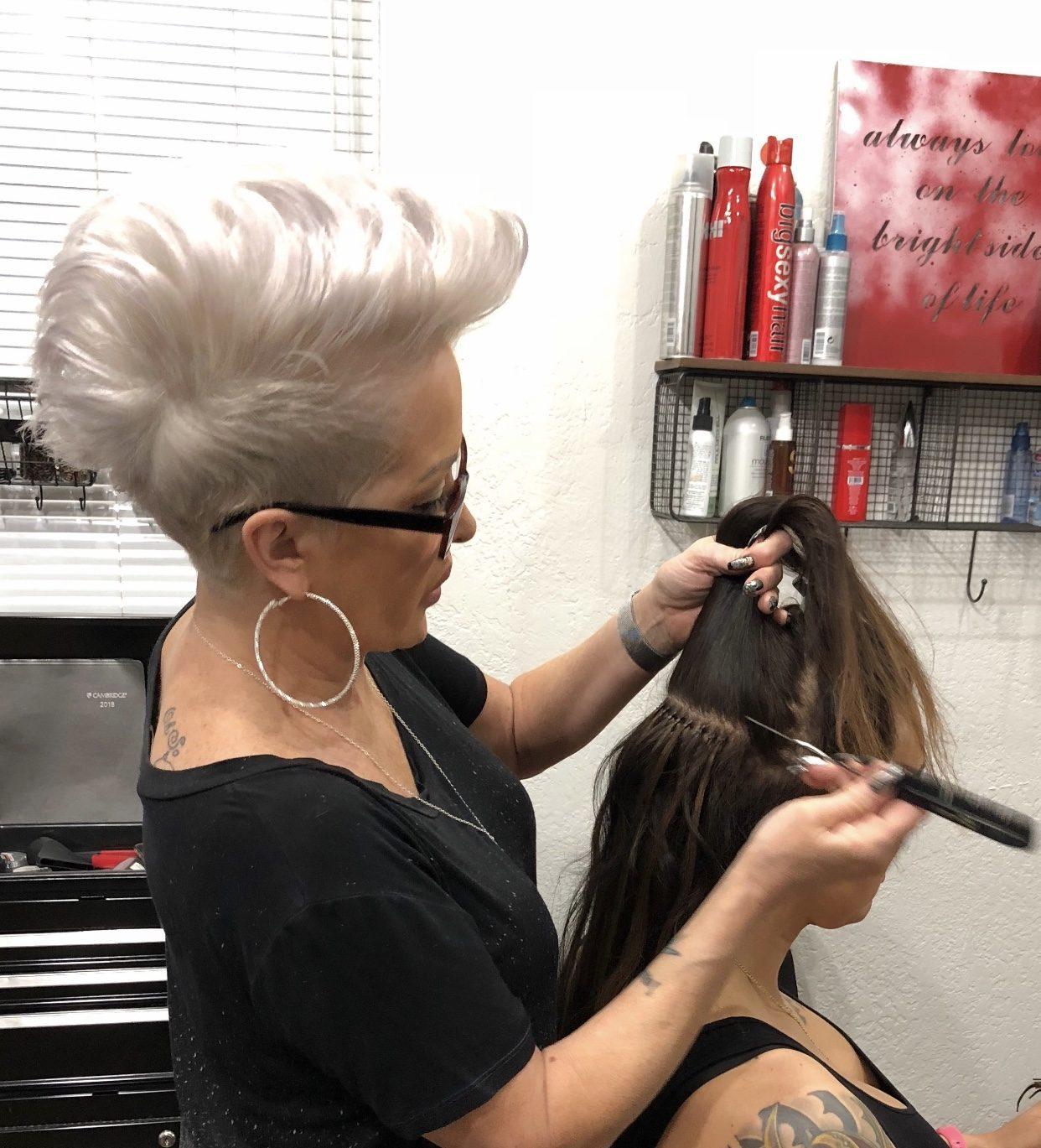 Ms Manae applying hair extensions in her Scottsdale salon